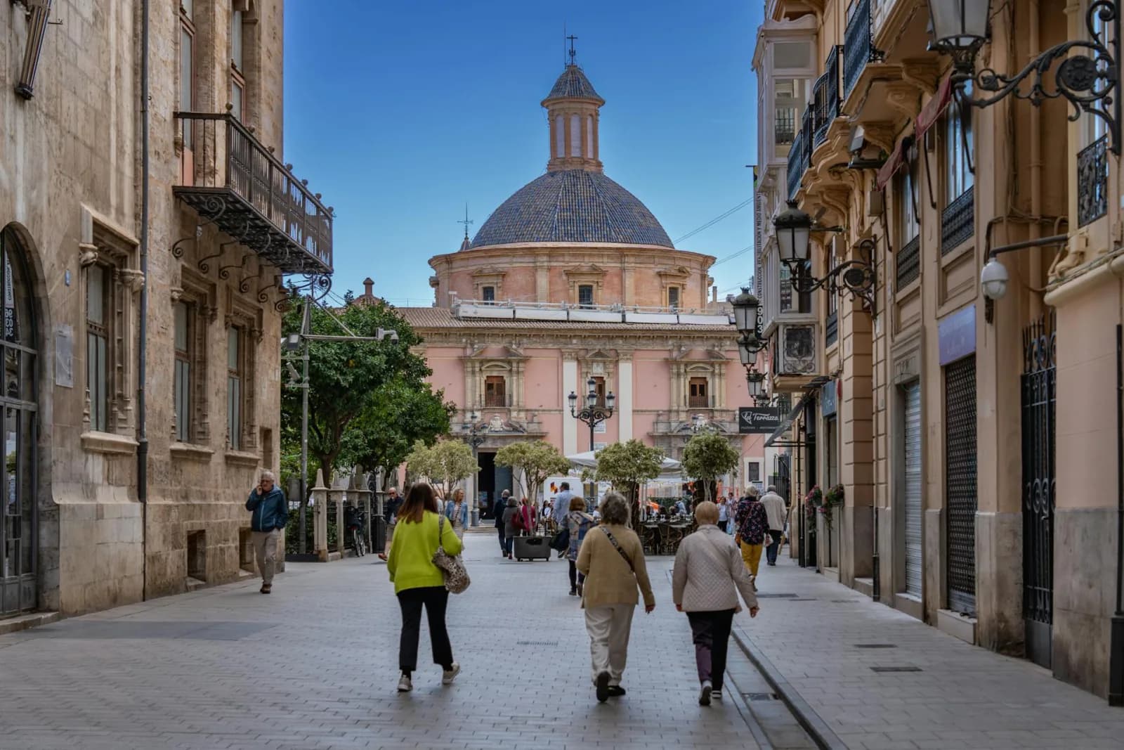 Street-level view of Valencia's El Carmen neighbourhood with locals walking and daily life activity