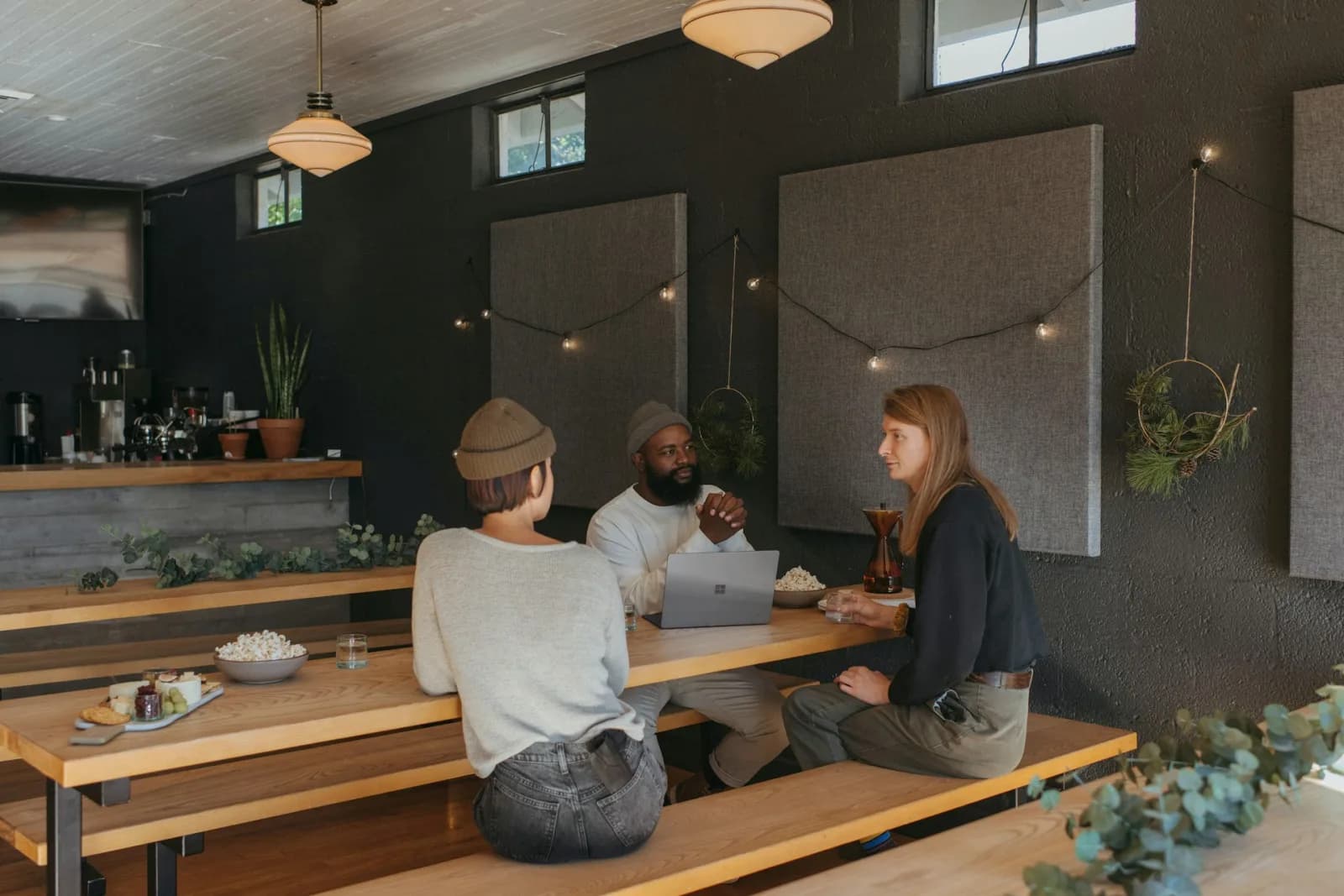 Small informal nomad gathering in a cozy space with coffee, laptops, and conversation