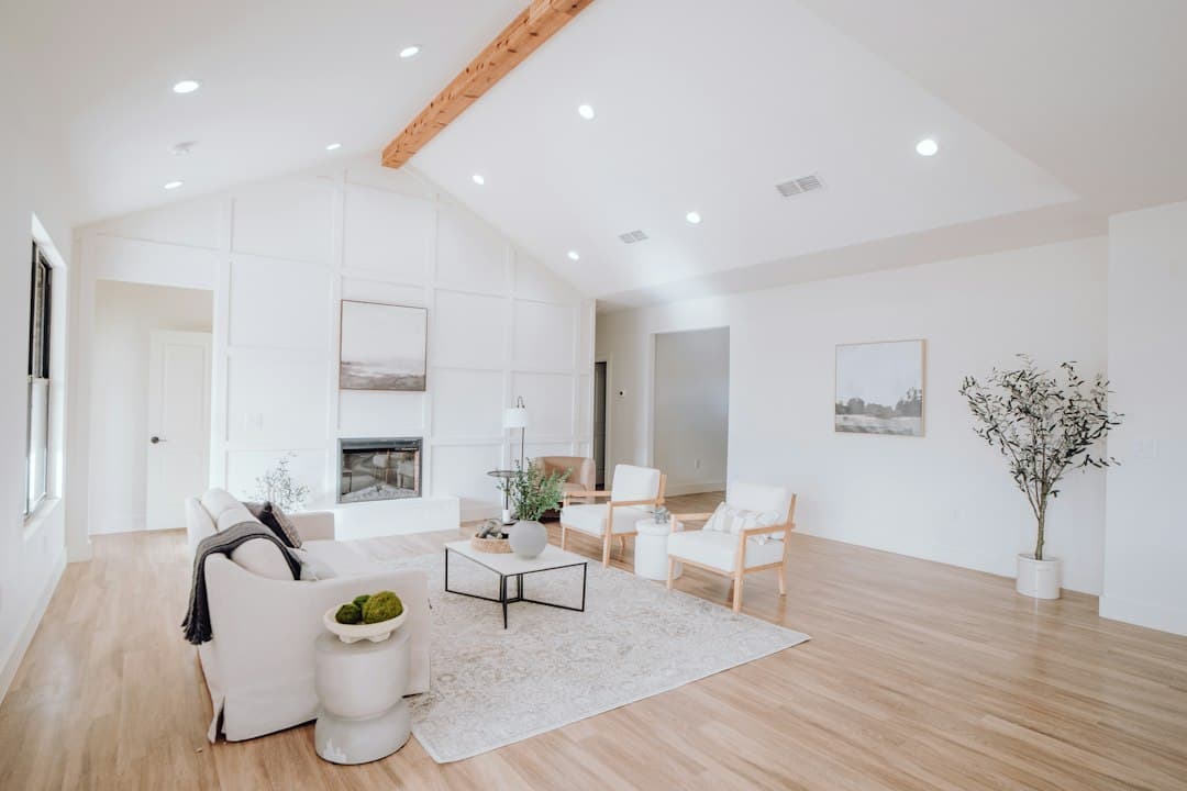 Portable air purifier in a modern, minimalist living room with hardwood floors and simple furniture.