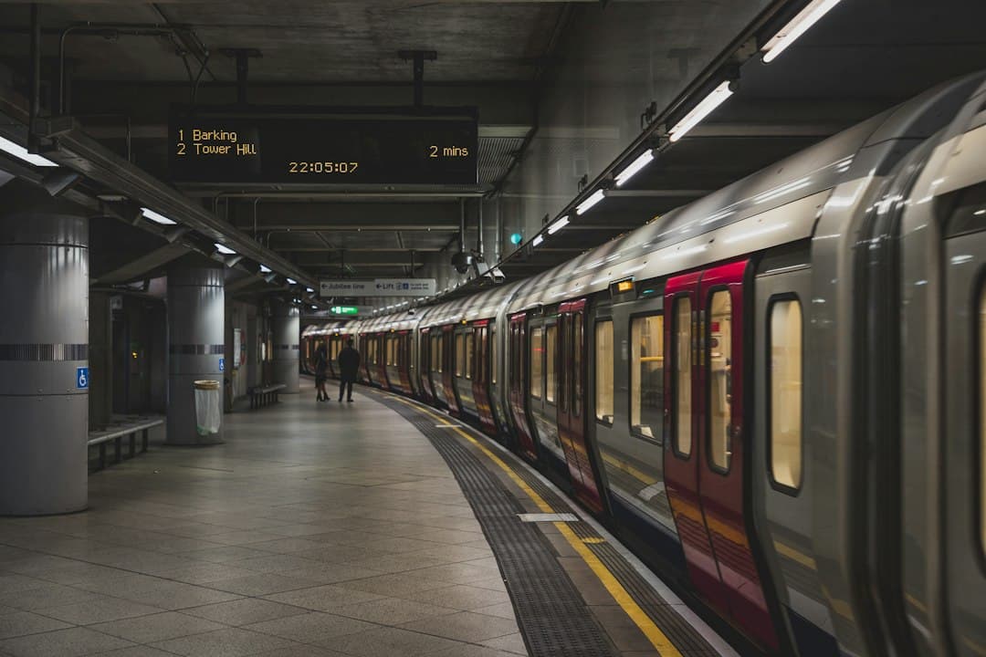 London Underground train at a station with passengers and visible signage