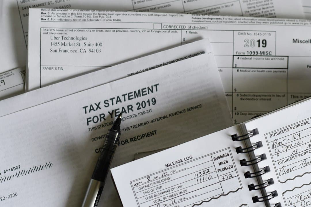 Tax documents and forms with a pen on a desk, illustrating tax filing and documentation.
