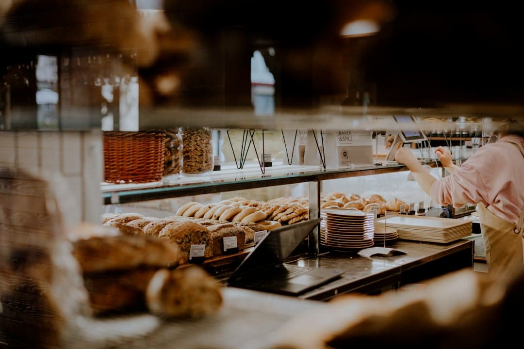 French bakery counter with breads, pastries, and customers respecting the queue.