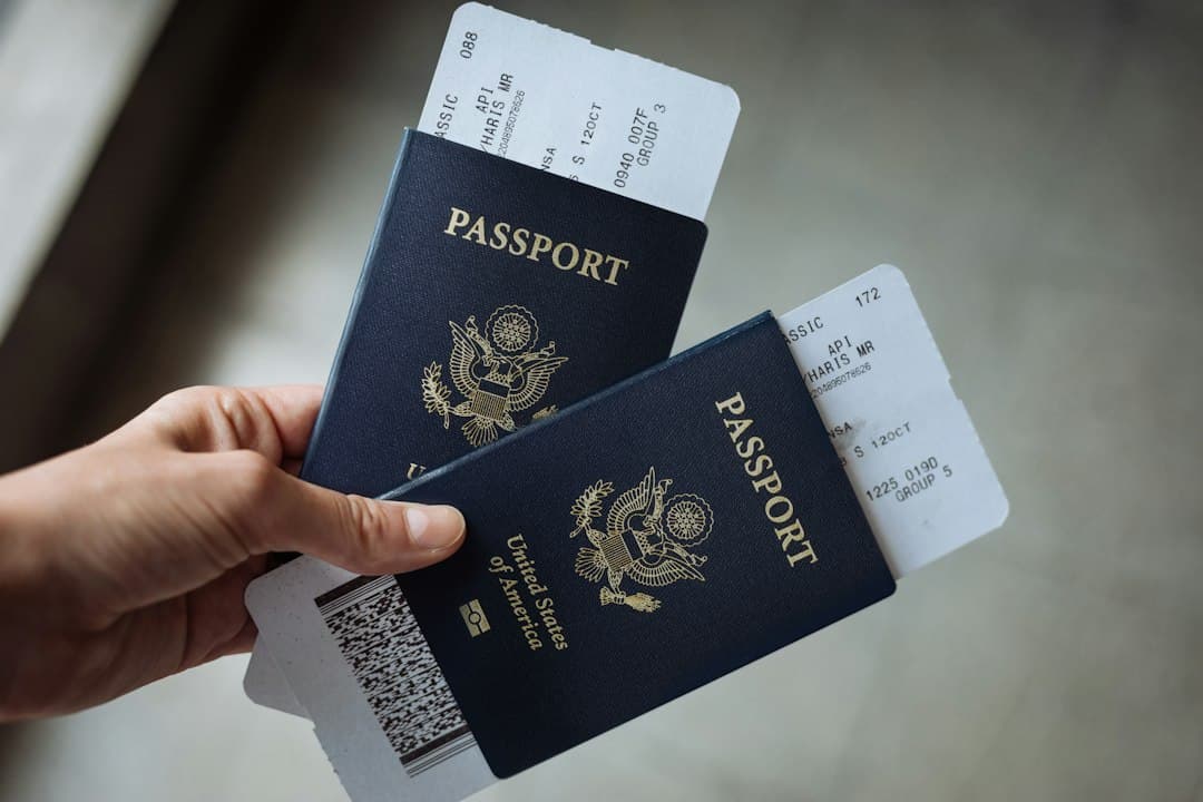 Hands holding two American passports with travel documents and boarding passes.