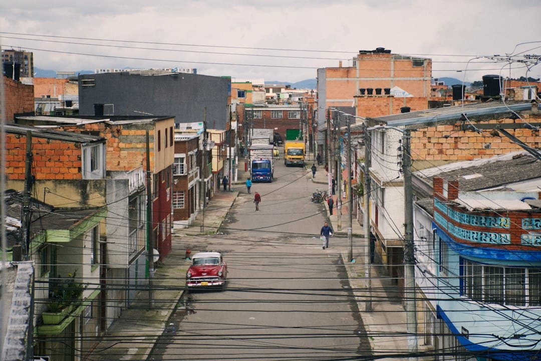 Overhead view of a quiet street in Bogotá, with brick buildings and overhead power lines.