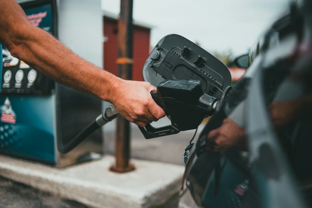 A person refueling with gasoline at a gas station.