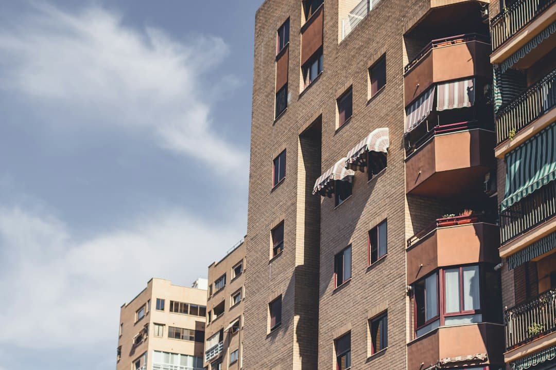 Valencian apartment building facade with balconies, drying laundry and varied architectural styles.