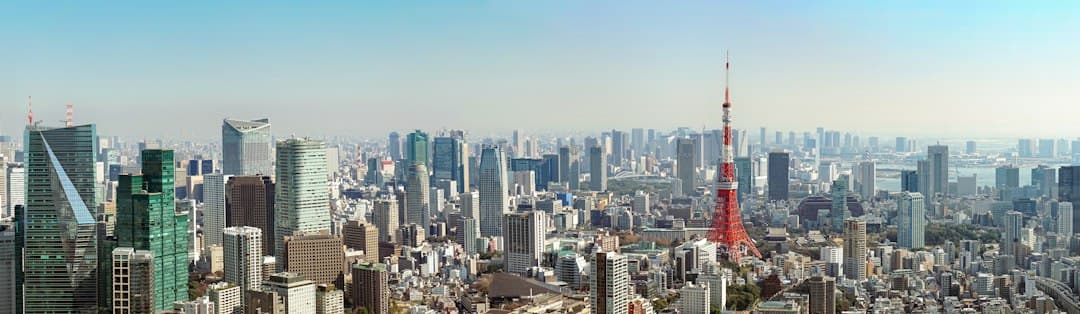 Panoramic view of Tokyo's business district with modern office buildings and Tokyo Tower