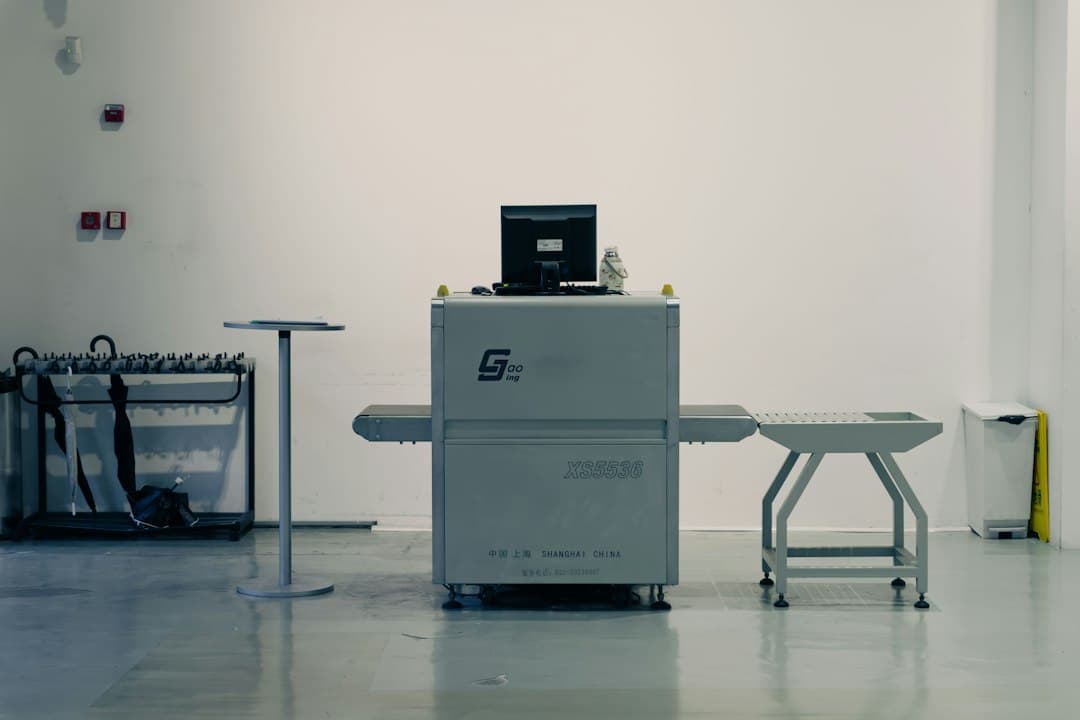 Baggage inspection machine at airport customs with a conveyor system.