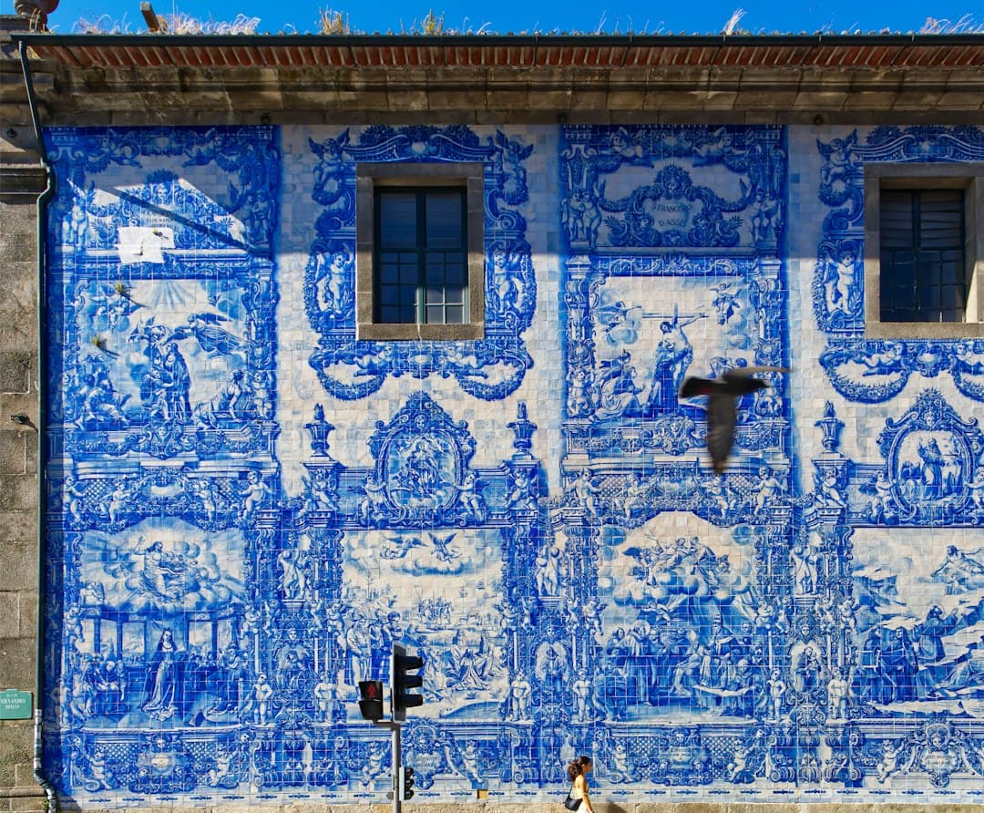 Traditional Portuguese façade covered in blue and white azulejos on a sunny day