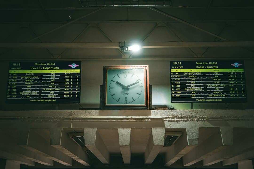 Station departure board showing times and destinations in green text.
