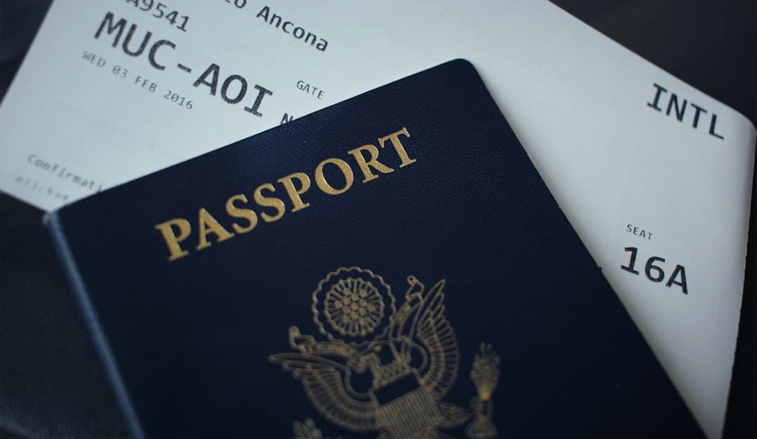Passport and boarding passes displayed on a dark background, representing travel documents.